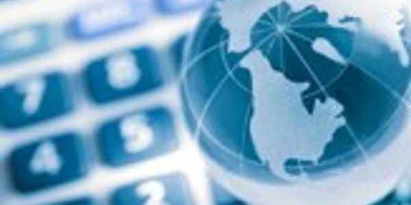 A globe on a blurred calculator, symbolizing global finance.