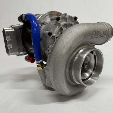 A close-up of a silver turbocharger with a blue hose on a white background.