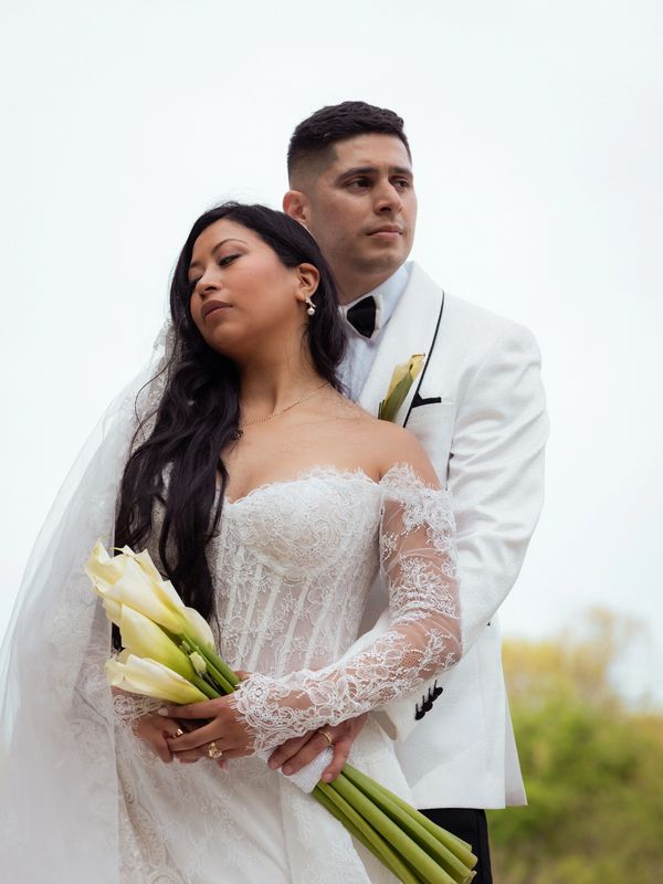 Bride and groom in elegant wedding attire.
