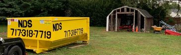 Dumpster ready to be filled with old shed and rubbish.