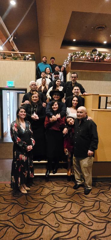 A group photo of people gathered indoors, smiling.