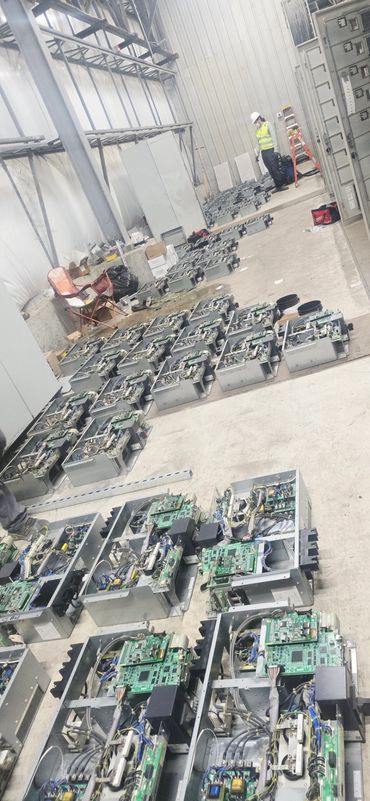 Warehouse with electronic circuit boards on the floor.