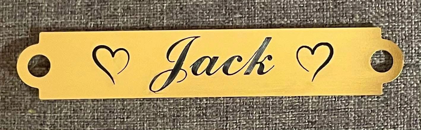 Yellow nameplate with 'Jack' and two heart designs.