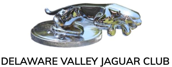 Chrome jaguar hood ornament on a coin with club name.