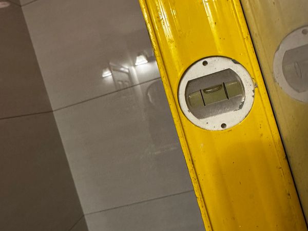 Yellow spirit level tool showing a bubble for leveling.