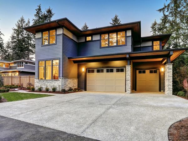 The modern style house boasts two car garages framed