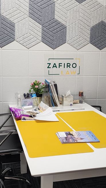 Modern law office desk setup with yellow mats and organized documents.