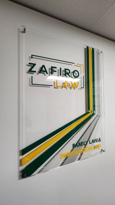 Sign for Zafiro Law with green and yellow accents.