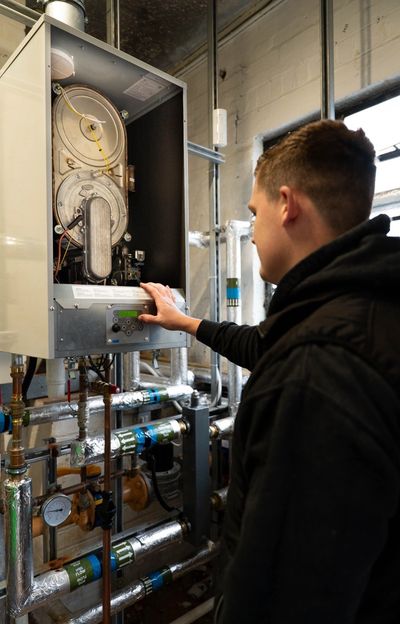 Technician inspecting a boiler system.