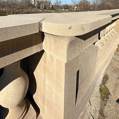 Close-up of a stone balustrade on a bridge in daylight.