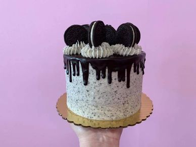 Cookies and cream cake covered in chocolate ganache and oreo cookies