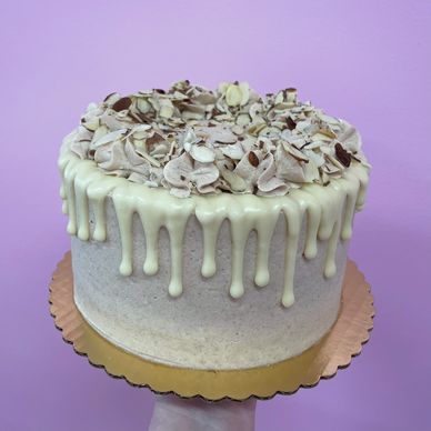 White almond cake with cream cheese, toasted almonds, and cinnamon buttercream frosting. 