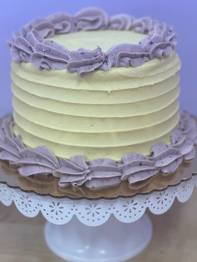 Lemon flavored cake with blueberries, blueberry buttercream filling, lemon frosting, and blueberry