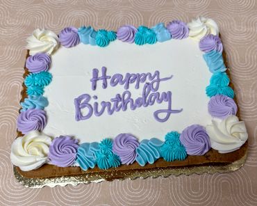 Rectangle chocolate chip cookie cake frosted in vanilla buttercream. 