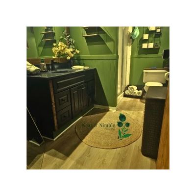 a bathroom with vanity, sink, mirror, toilet. shower towels. and throw rugs. 