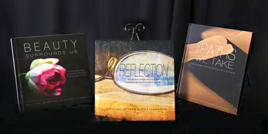 Covers of inspirational coffee table books  - Beauty Surrounds Us, The Paths We Take, & Reflection 