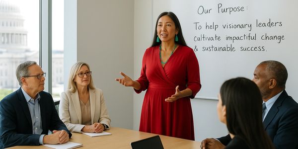 A native woman is in front of a group of fellow executives, leading a discussion.