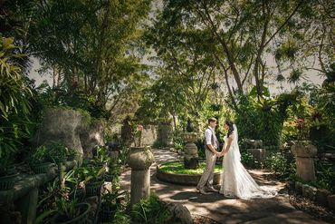 Hand in hand through a fairytale forest — love hidden in the heart of a tropical paradise.