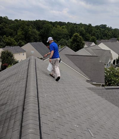 Insurance claims adjuster inspecting roof for hail and wind damage