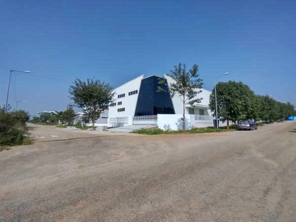 aerospace park modern industrial complex on rent with large buildings and green lawn under clear sky