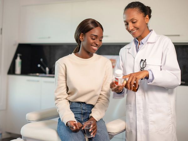 A doctor helping a patient with her medication