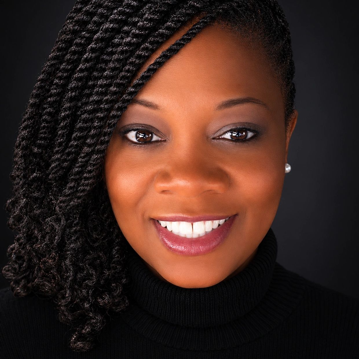 Picture of African American woman smile with hair in twists.