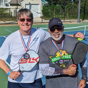 Coach Karl and Coach Eric with our medals after a recent tournament.