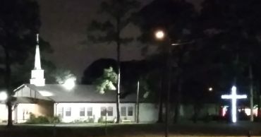 A church building illuminated at night.