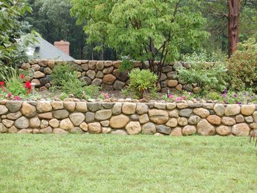 Landscape with natural stone wall and trees.