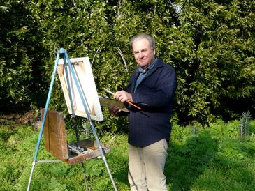 An artist painting outdoors.