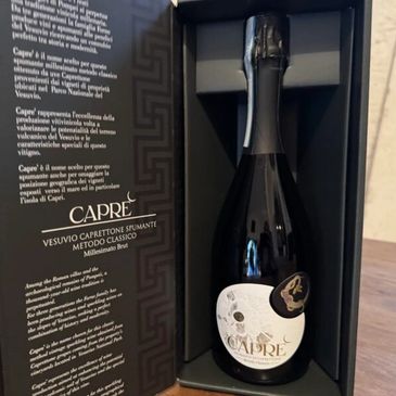 Elegant Caprè Vesuvio sparkling wine bottle in luxury box.