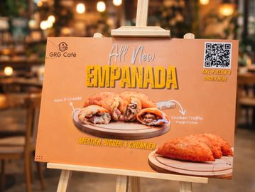Advertisement for new meatier, bigger, chunkier empanadas at GRG Café.