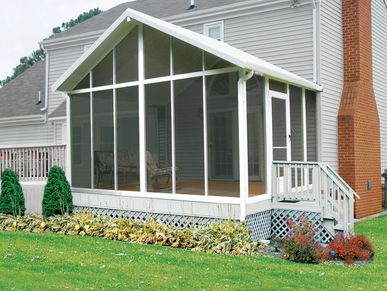 Gable style screen room with stairs and railing in white attached to house.