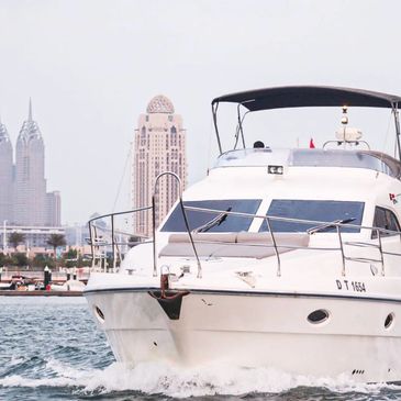 A 50-Feet Euphoria yacht cruising along Dubai Marina - For Sight seeing