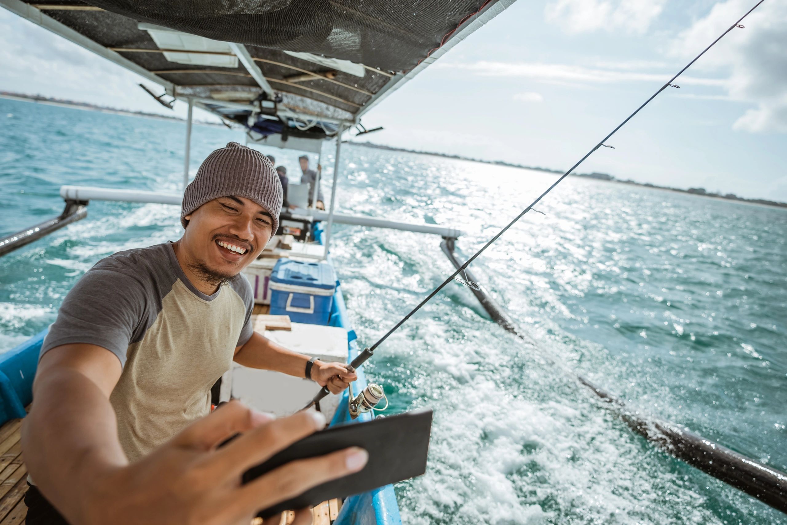 Visual of Man enjoying fishing from Top8 yachts and clicking a selfie of his memorable experience