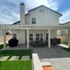 Solid white Patio cover install on top of gray charcoal pavers with dark border in moorpark