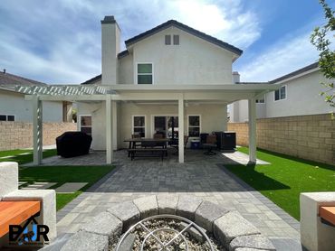 Gray charcoal pavers, marathon turf and stepping stone 2x2 in a new backyard.