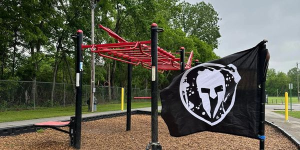 Spartan race flag on a playground obstacle course.