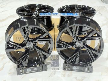 Glossy black alloy car wheels with a modern multi-spoke design.