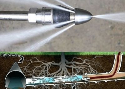 Water jet nozzle cleaning a city sewer pipe underground.