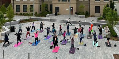 People doing outdoor yoga at Lost Shoe Brewing & Roasting taproom in Marlborough, MA.