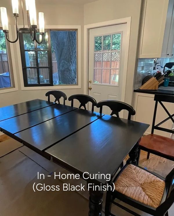 Gloss black finished dining table in a home setting.