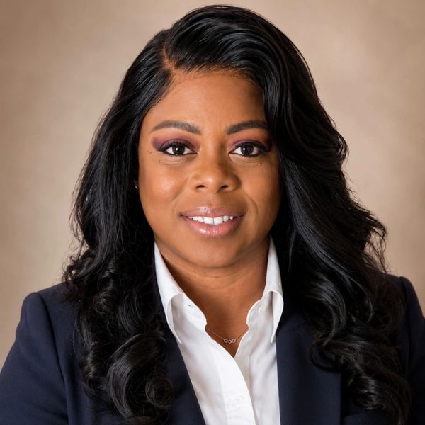 Professional woman with long black hair in business attire.