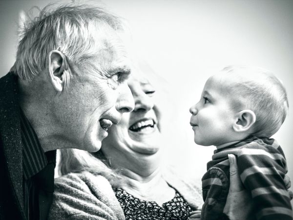 family photo, grandad making little boy laugh, family portrait 