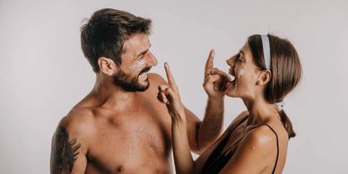 Man & women playfully applying tallow balm by Ancient Secrets