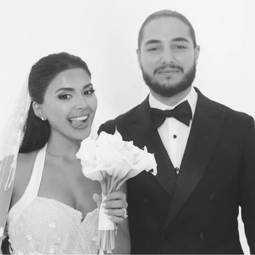 Bride and groom posing happily on their wedding day.