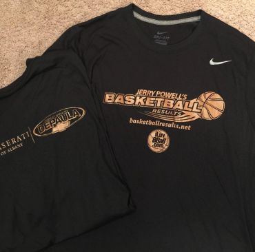 Two black basketball-themed T-shirts laid out on a carpet.