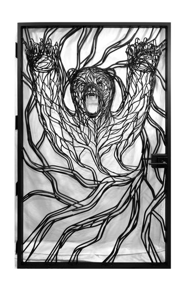 A metal bear gate in Zephyr Cove, NV. The bear is handmade sculptural steel and looks as though it i