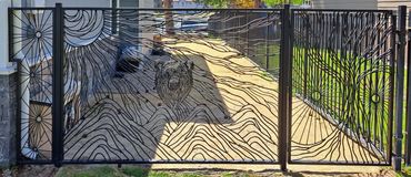 Custom metal art functional art fence and gate with bear and mountain and space imagery.
