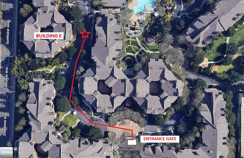 Aerial view of apartment complex with path from entrance gate to Building E marked in red.